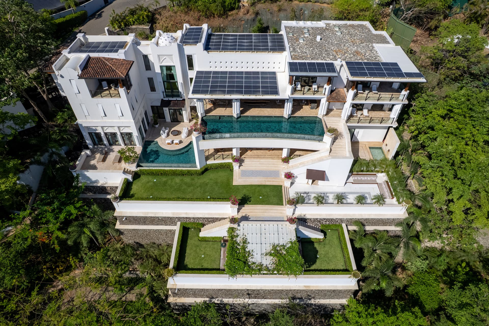Villa Luciérnaga from directly above — pool, terraces, and rooftop solar