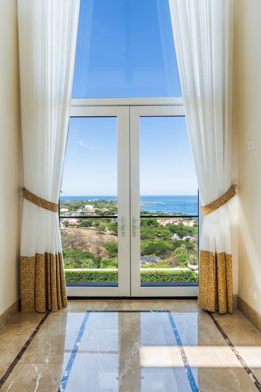 Linen curtains framing an unobstructed Pacific view