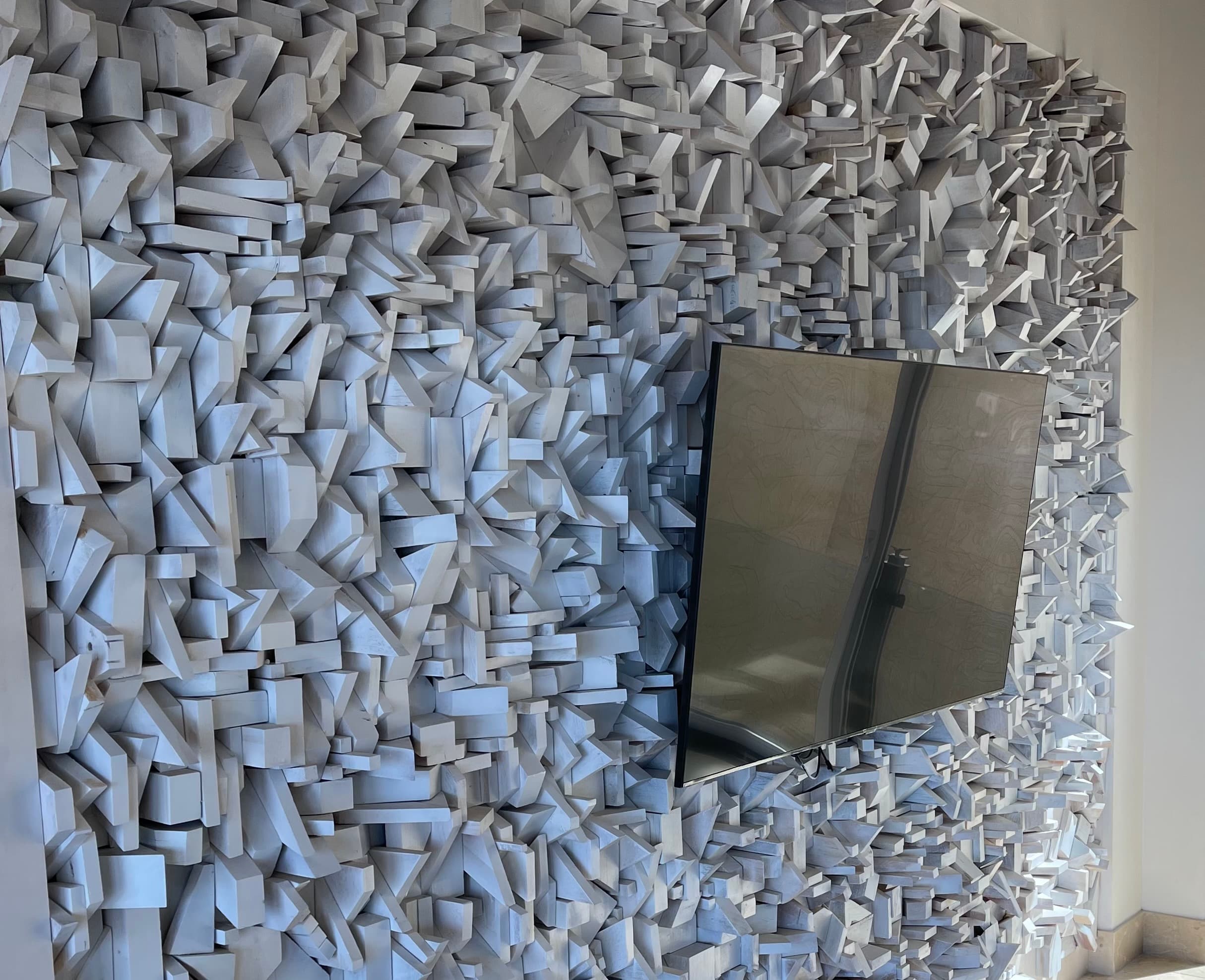 The reclaimed wood feature wall in the great room -- Abraham Valenzuela built it himself from leftover construction wood; the television is intentionally mounted within it